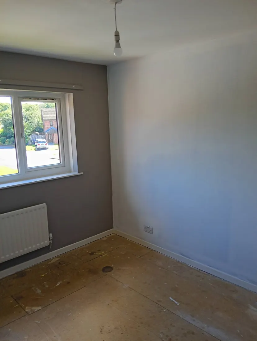 Empty interior room with freshly painted neutral grey and white walls